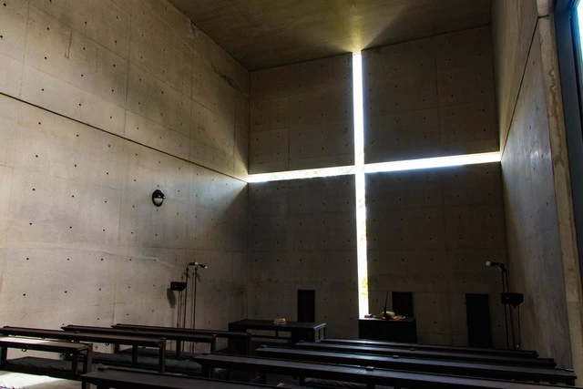 Tadao Ando Church of Light interior concrete wall with cross-shaped opening streaming natural light Osaka Japan