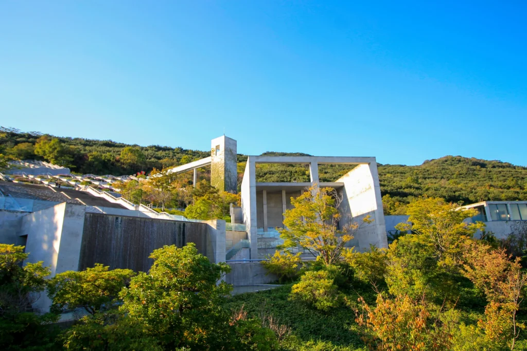A meditative perspective of Tadao Ando’s concrete terraces at Hyakudanen, where geometric repetition meets the vastness of the sea.