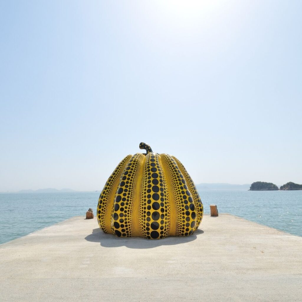 Naoshima art island Japan yellow Yayoi Kusama pumpkin sculpture on pier with Seto Inland Sea